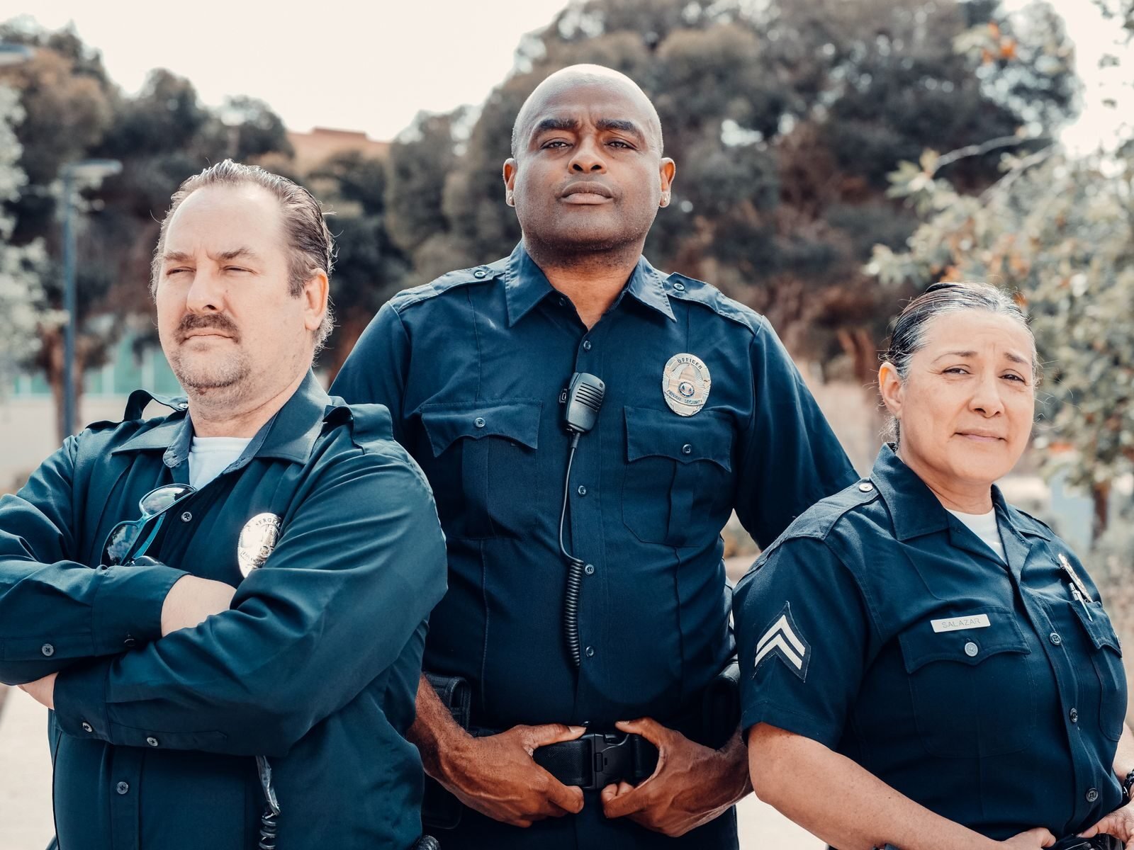 Group of diverse police officers posing outdoors, emphasizing unity and public safety.