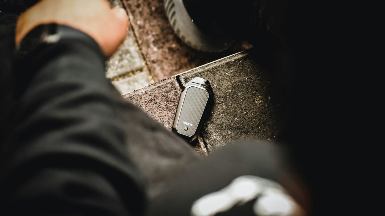 black and gray electric cigarette near left person's hand
