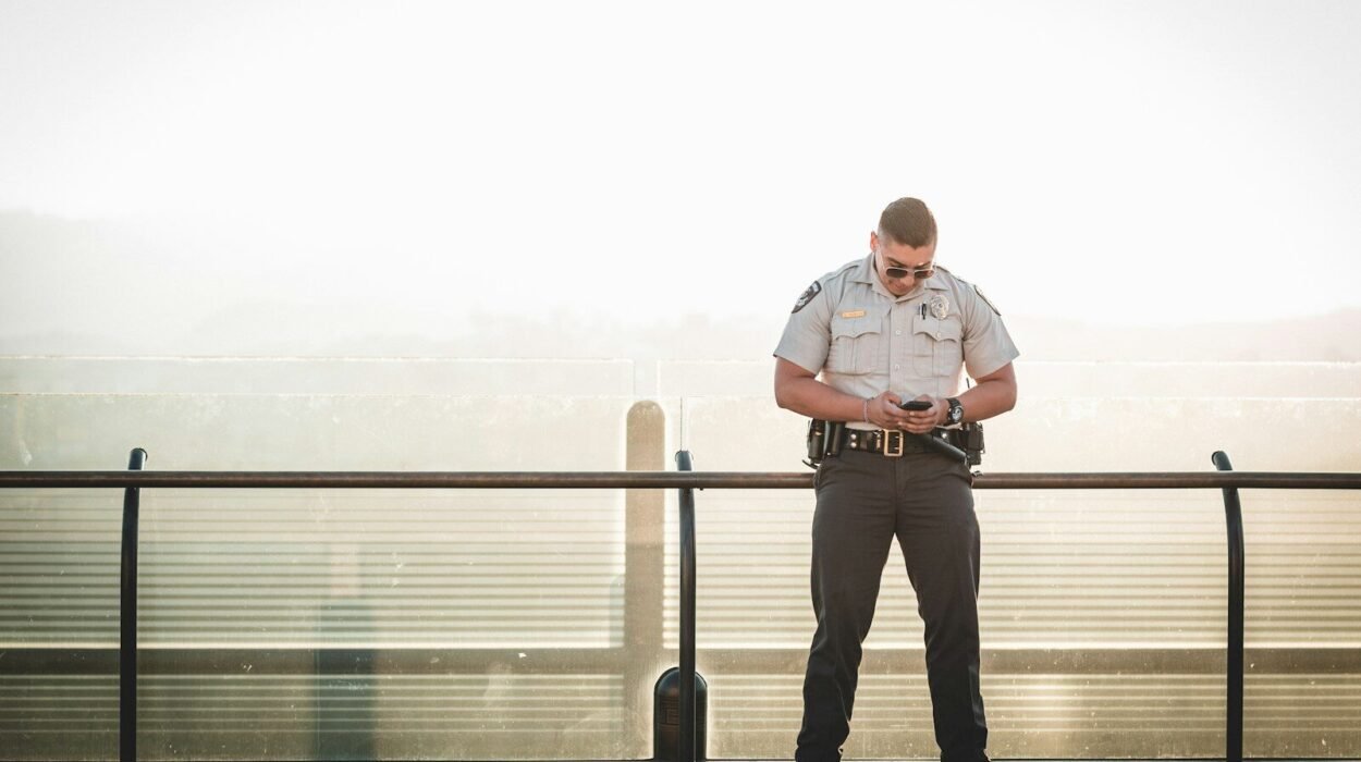 cop leaning on metal rail during a sunny day