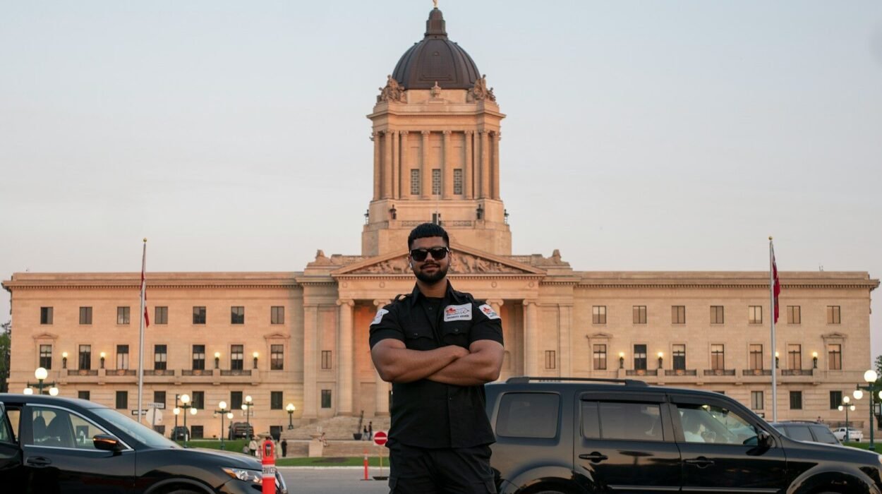 A man stands in front of a building