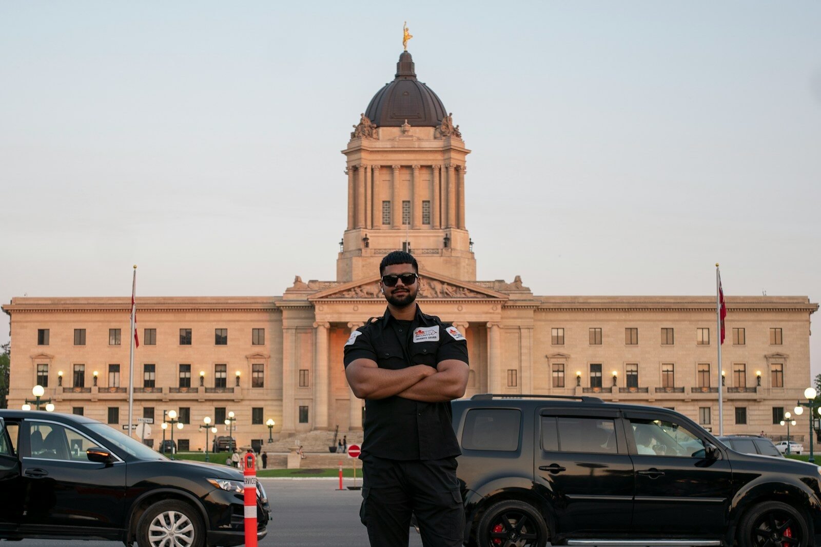 A man stands in front of a building