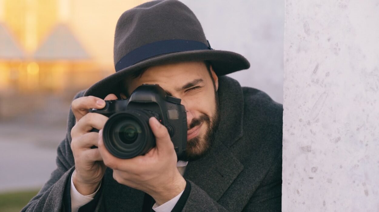 Man in hat taking picture with professional camera.