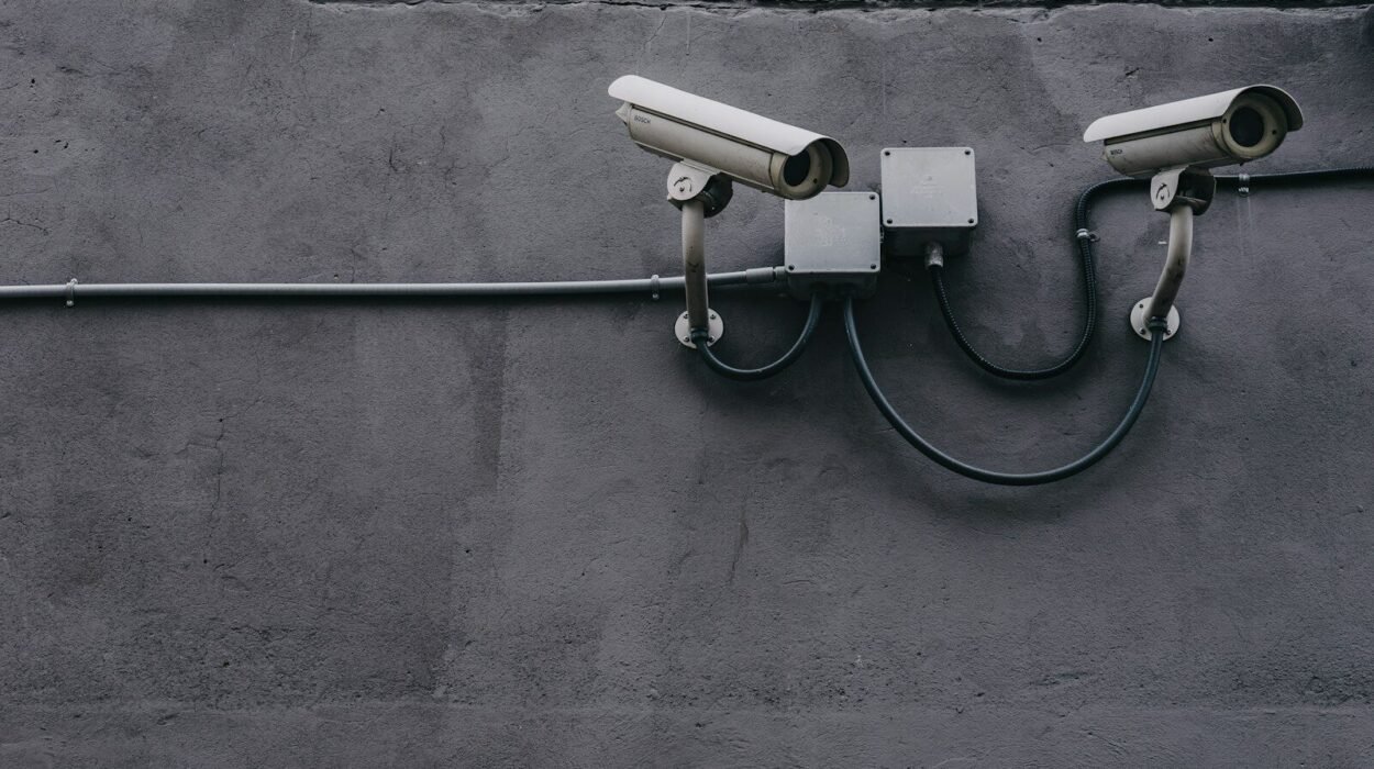 two bullet surveillance cameras attached on wall