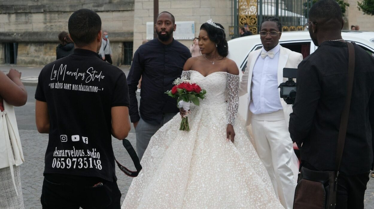 man in black crew neck t-shirt holding white bouquet