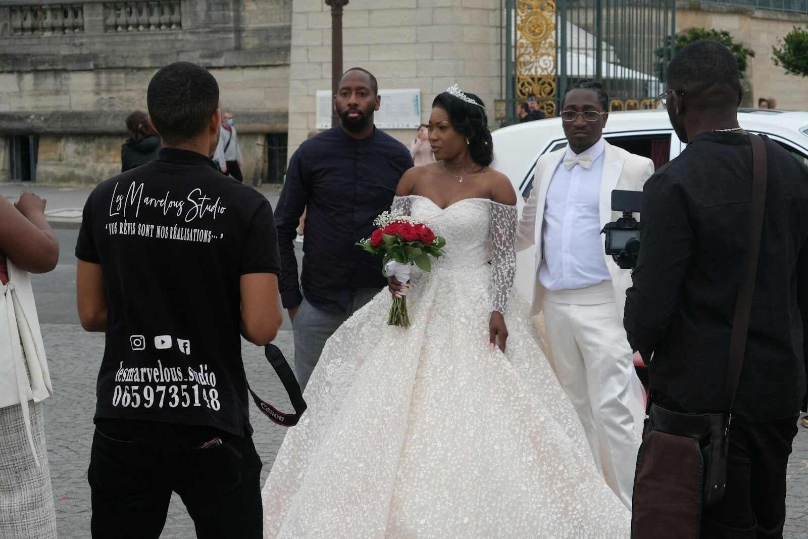 man in black crew neck t-shirt holding white bouquet