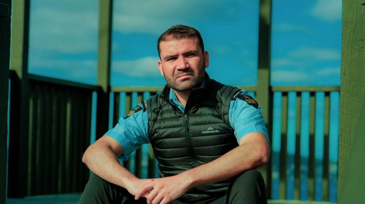 Security guard sitting outdoors in uniform. Ideal for security and occupation themes.