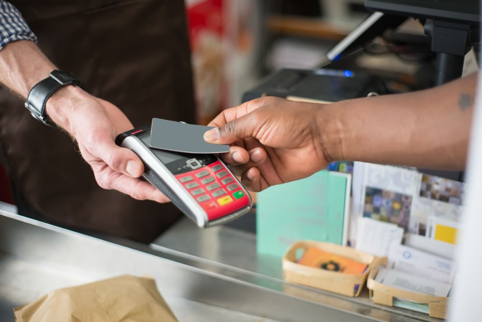 Close-up of a contactless payment transaction in a retail setting.
