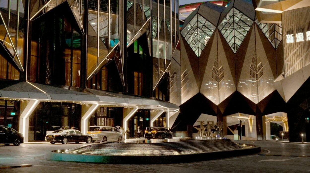 Modern architectural building with cars outside at entrance