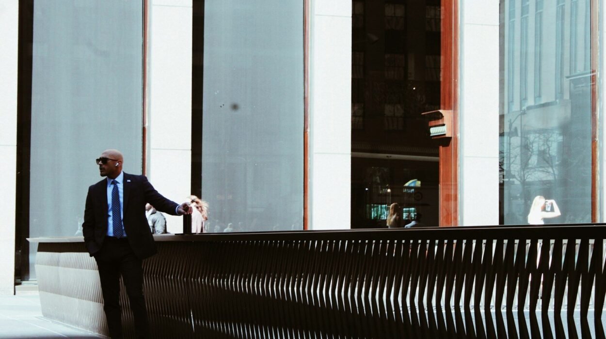 Man in suit standing by modern building