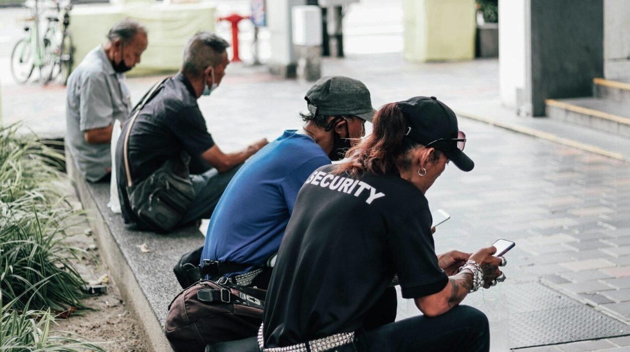 a group of people sitting on the side of a street